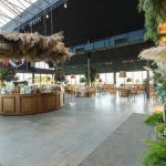 Stylish indoor wedding venue with rustic decor and floral elegance, perfect for a spacious celebration. — Bathroom Wall Panel